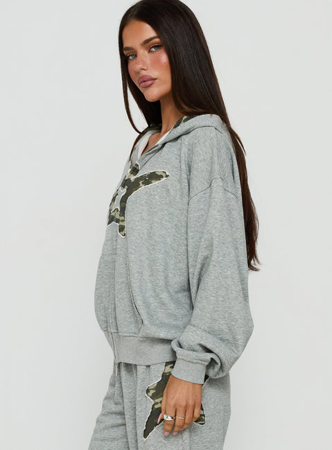 Designed with the Chelzie Zip Through Graphic Hoodie Grey Marle / Camo in womens jumpers featuring oversized fit, hood details, camo print, and short length side view of model wearing Princess Polly