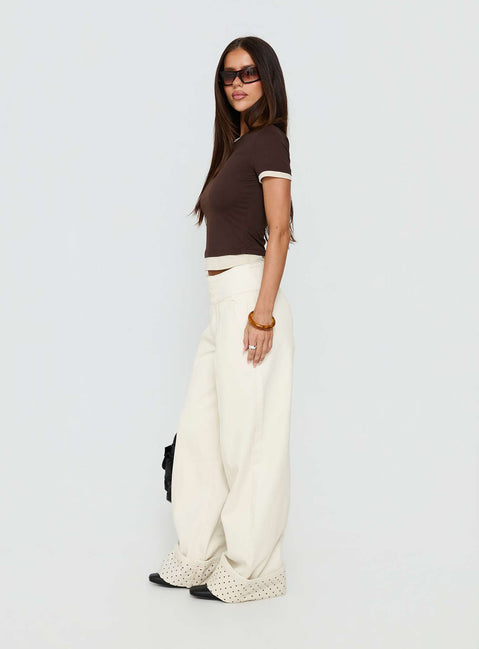Discover the Nikoletta Foldover Jeans Cream / Polka Petite womens-jeans with high-rise side view of model wearing Princess Polly