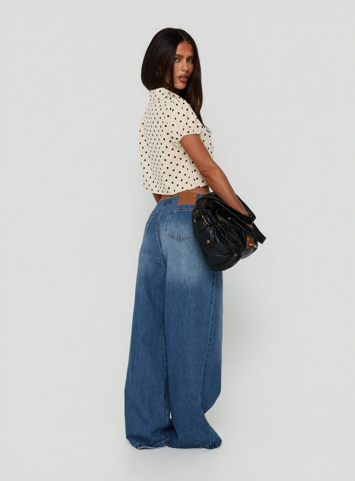 Designed with Roamer No Waist Low Rise Super Baggy Vintage Mid Blue womens jeans in low-rise waist back view of model wearing Princess Polly