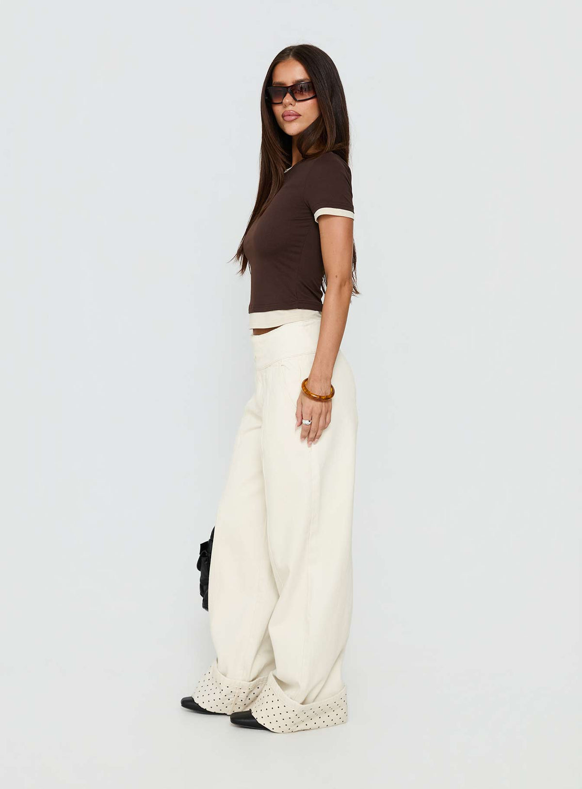 side view of model wearing Princess Polly Nikoletta Foldover Jeans Cream / Polka Mid Rise Jeans Jeans 