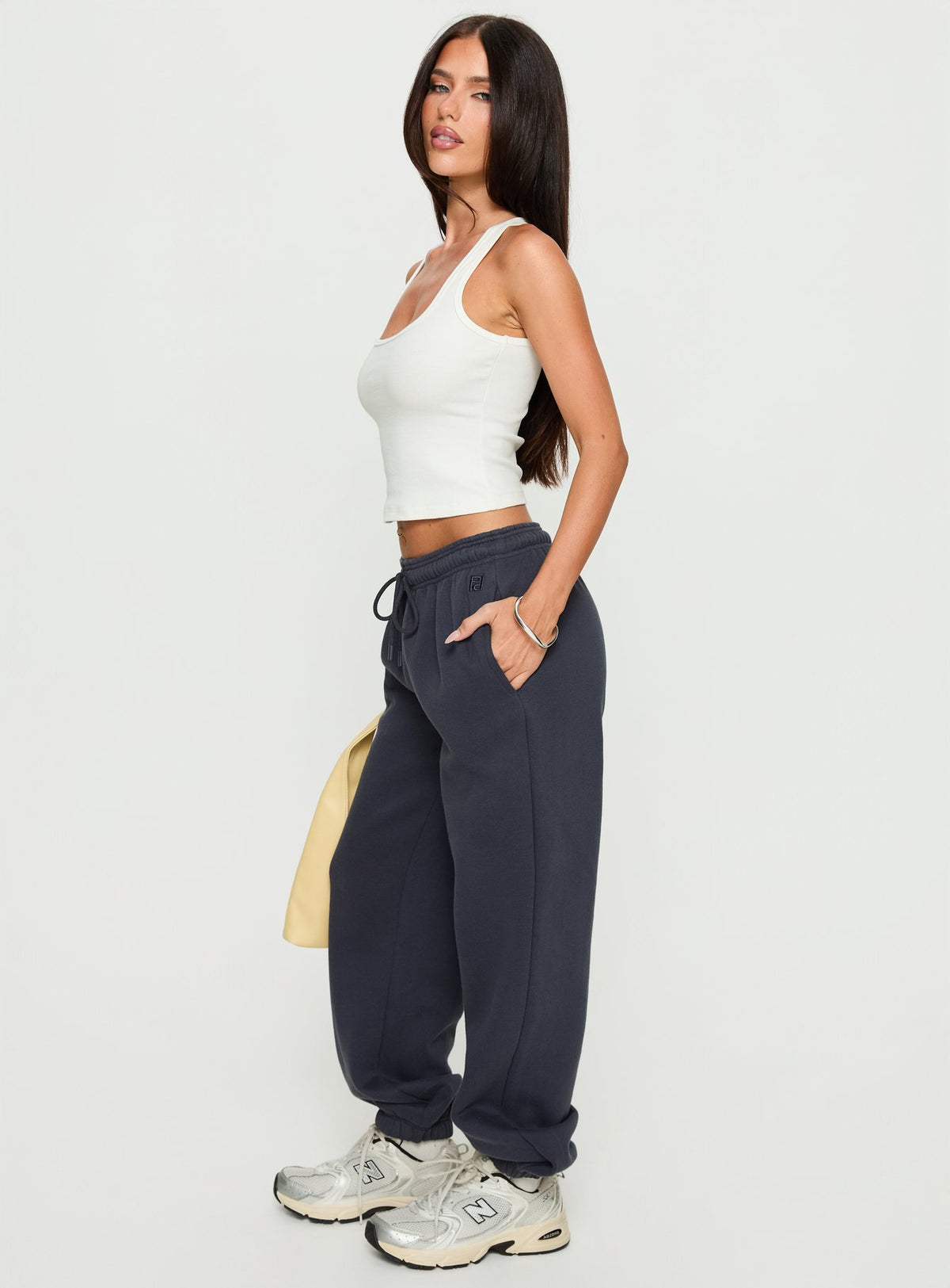 side view of model wearing Princess Polly Caspa Dream Fleece Oversized Ankle Cuff Jogger Navy High Rise Pants Pants 