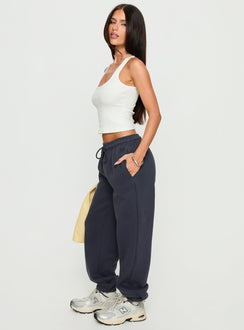 side view of model wearing Princess Polly Caspa Dream Fleece Oversized Ankle Cuff Jogger Navy High Rise Pants Pants 
