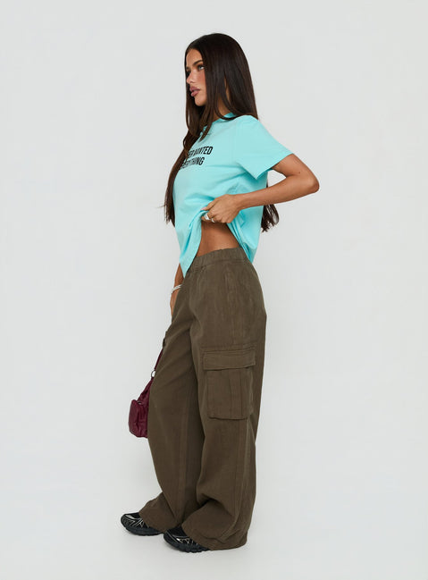 Designed with high-rise detailing, the Scarletta Ultra Wide Elasticated Waist Cargo Pants Khaki in womens regular pants side view of model wearing Princess Polly