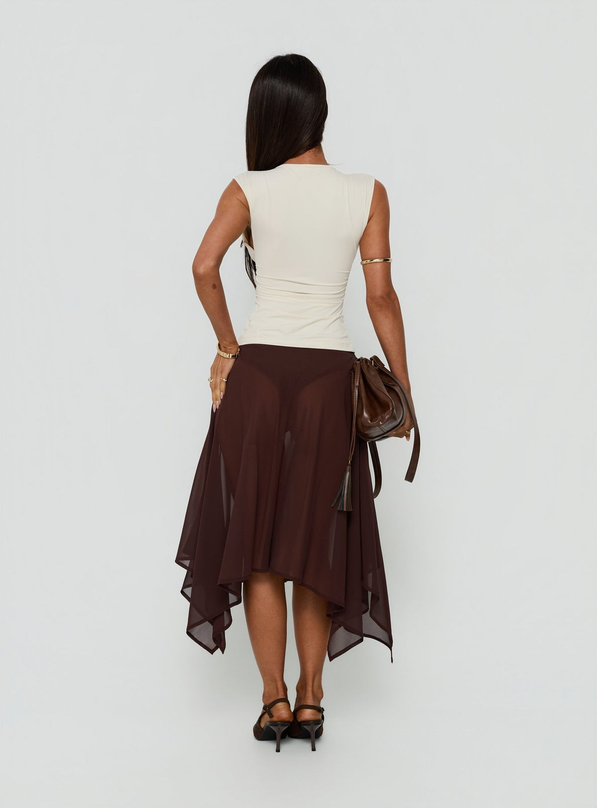 Shop the Asali Asymmetrical Midi Skirt Chocolate womens-skirts in length back view of model wearing Princess Polly