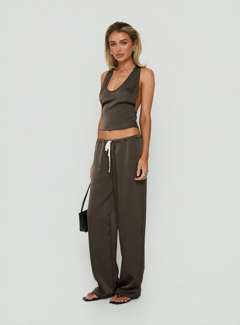 Featuring the Dialled Up Tie Waist Satin Pants Mocha in womens regular wide-leg silhouette with mid-rise belt side view of model wearing Princess Polly