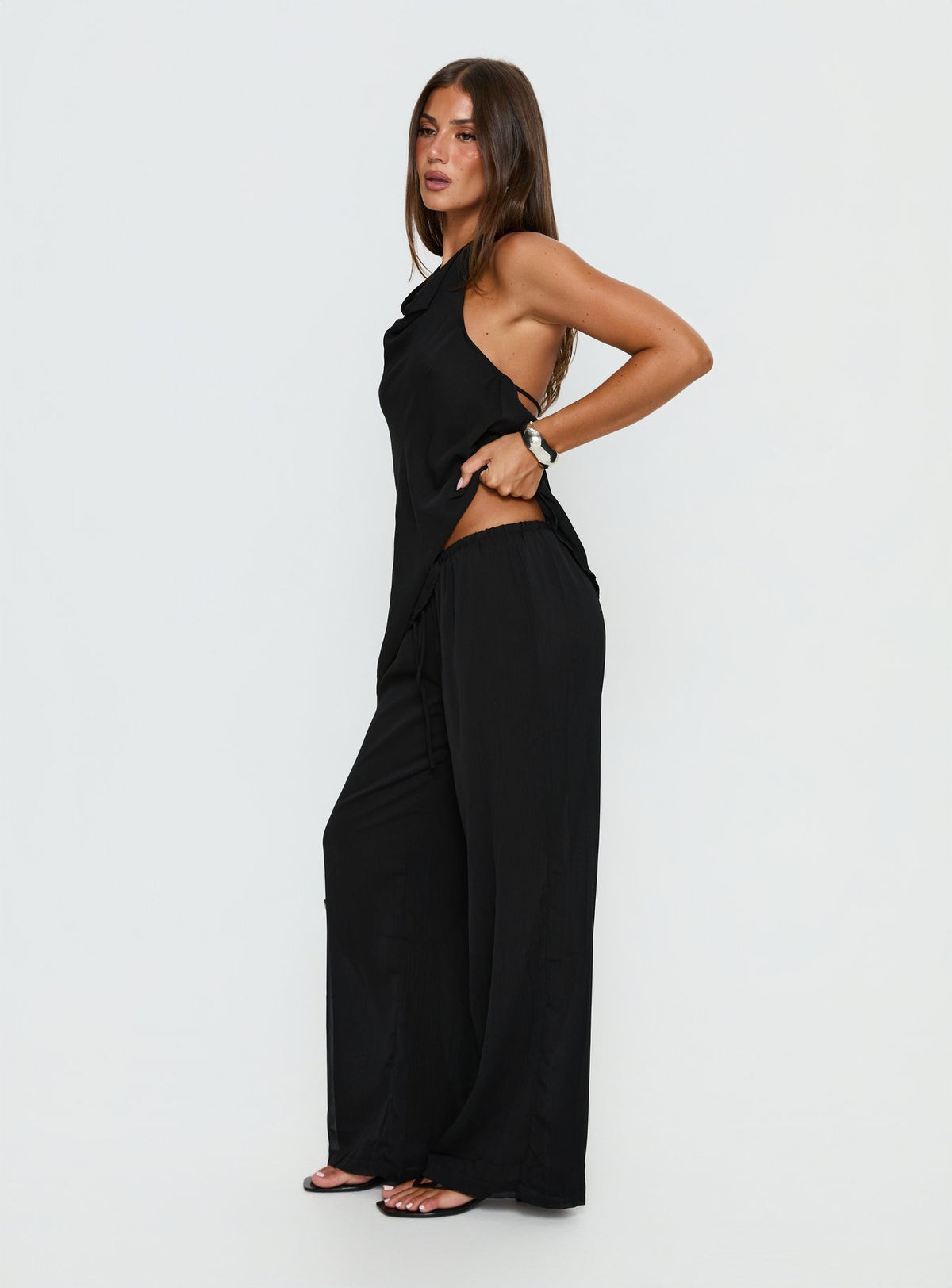 side view of model wearing Princess Polly Emorisa Mid Rise Chiffon Pant Black Mid Rise Pants Pants 