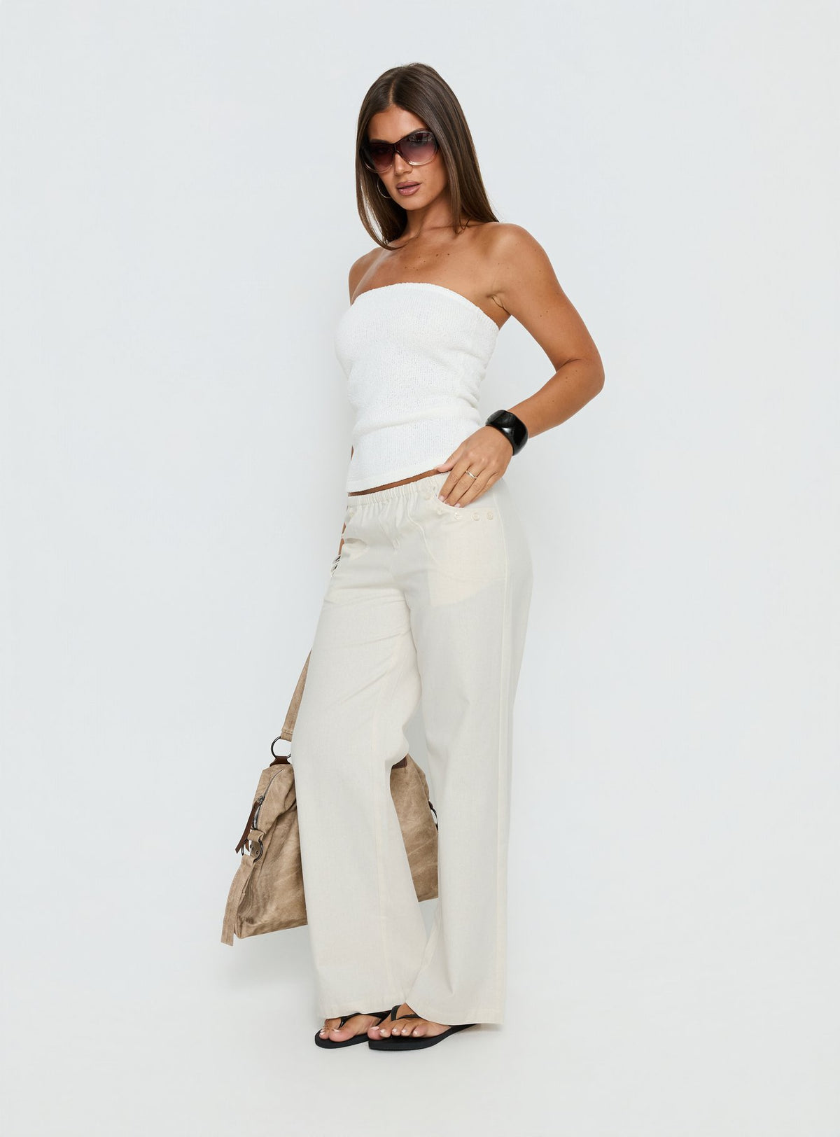 side view of model wearing Princess Polly Around The Clock Button Detail Mid Rise Wide Leg Pants Cream Mid Rise Pants Pants 