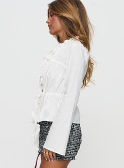 side view of model wearing Princess Polly Harloe Ruched Tie Up Long Sleeve Top White Full Sleeves V-Neck 