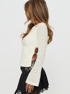 side view of model wearing Princess Polly Shellee Long Sleeve Tie Back Top Cream Full Sleeves Crew Neck 