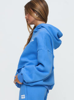 side view of model wearing Princess Polly Princess Polly Hooded Sweatshirt Bubble Text Blue / White Jumpers 