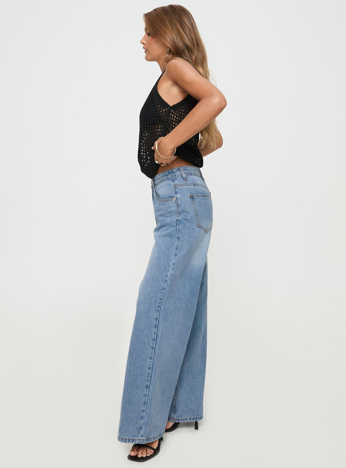 side view of model wearing Princess Polly Colemane Mid Rise Flared Jeans Angel Blue High Rise Jeans Jeans 