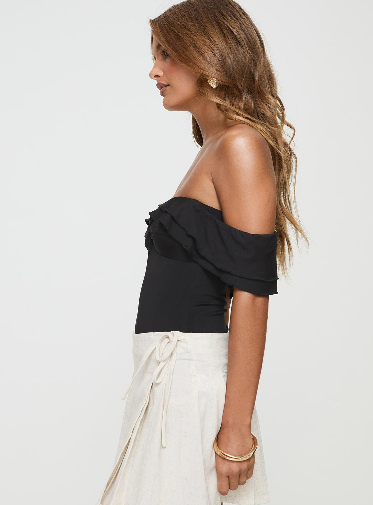side view of model wearing Princess Polly Coming Back Ruffle Bodysuit Black Sleeveless Bodysuit 