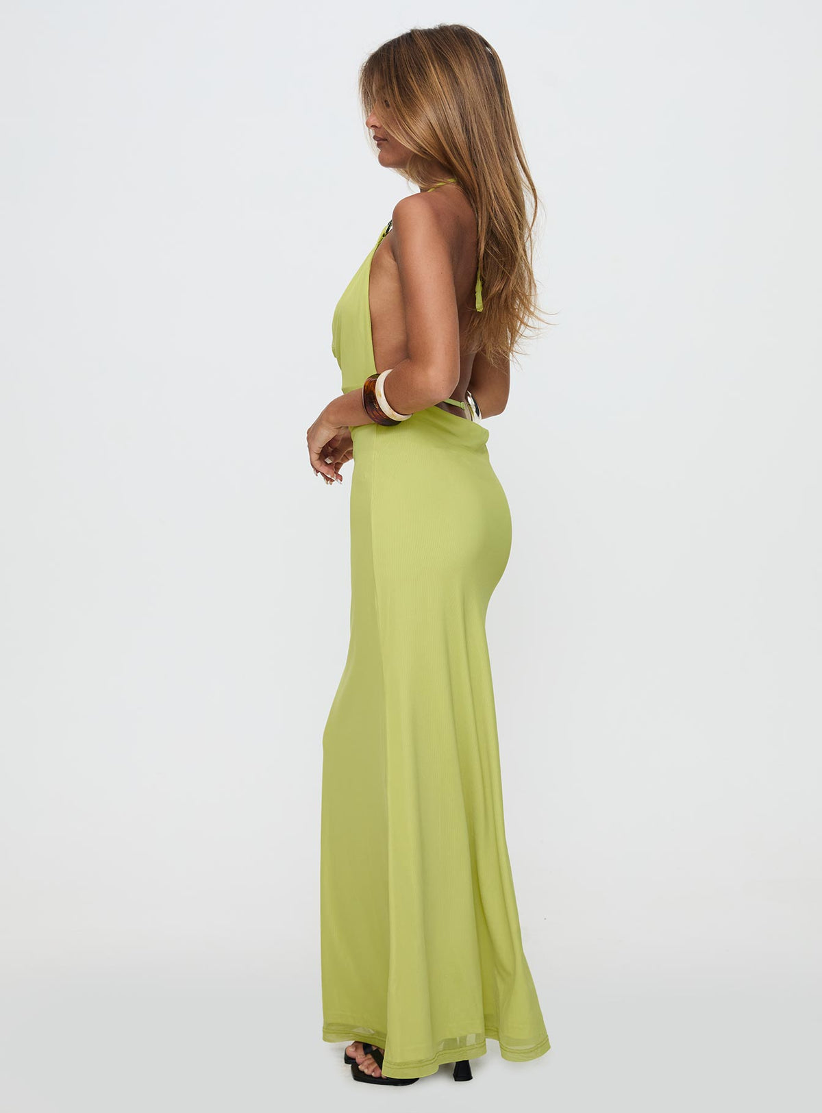 side view of model wearing Princess Polly Rhaenyra Halter Maxi Dress Green Plunger 