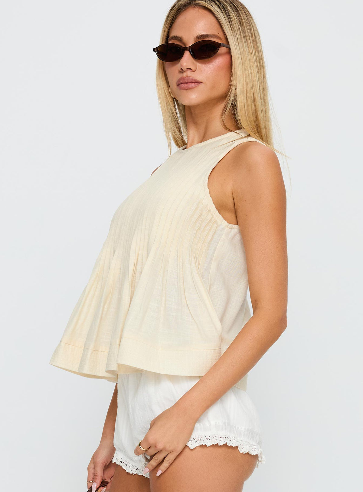 side view of model wearing Princess Polly Lavish Life Top Beige Sleeveless Crew Neck 
