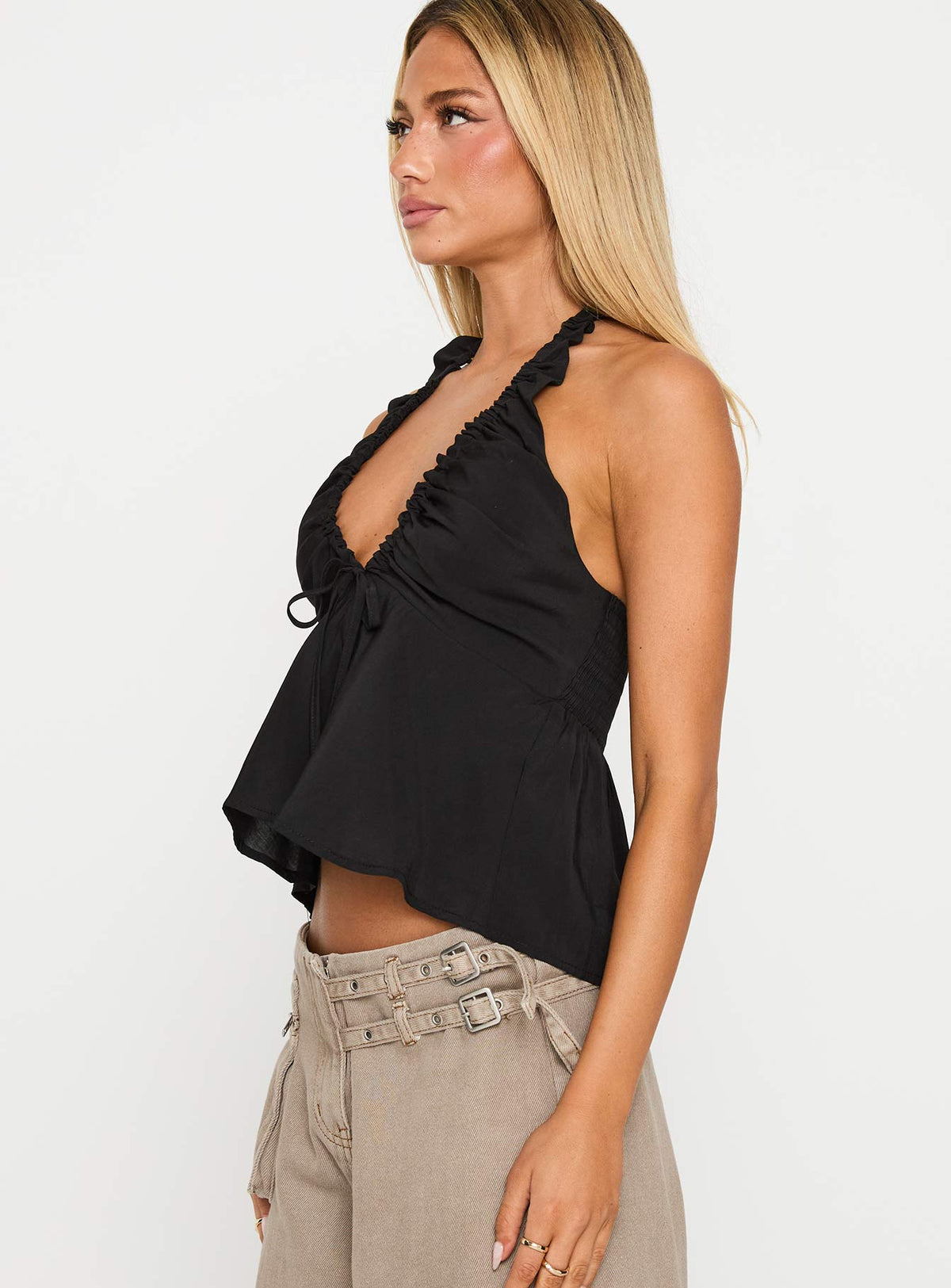 side view of model wearing Princess Polly Gadot Halter Top Black Sleeveless Plunger 