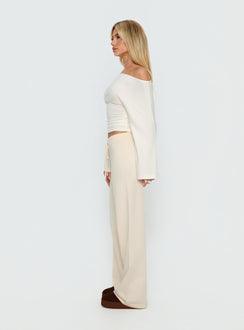 side view of model wearing Princess Polly Felisha Low Waist Knit Pants White Mid Rise Pants Pants 