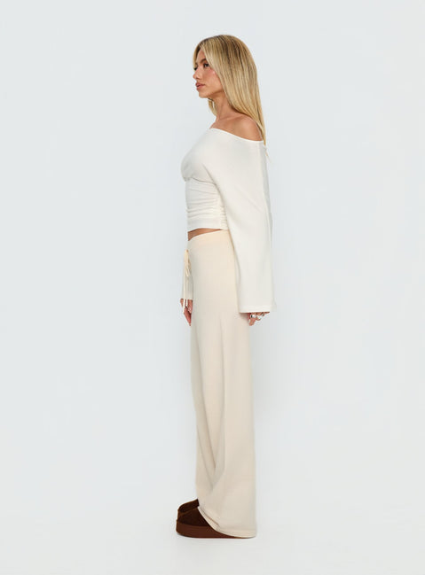 side view of model wearing Princess Polly Felisha Low Waist Knit Pants White Mid Rise Pants Pants 