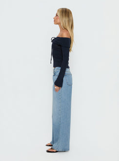Featuring the Ellanor Low Rise Slouch Denim Jean Washed Mid Blue Wash Tall womens-jeans side view of model wearing Princess Polly