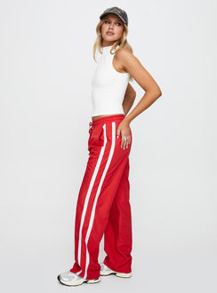 side view of model wearing Princess Polly Keli Track Pants Red / White High Rise Pants Pants 