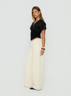 Explore the Ramos Low Rise Wide Leg Jeans in Cream womens-jeans with low-rise waist side view of model wearing