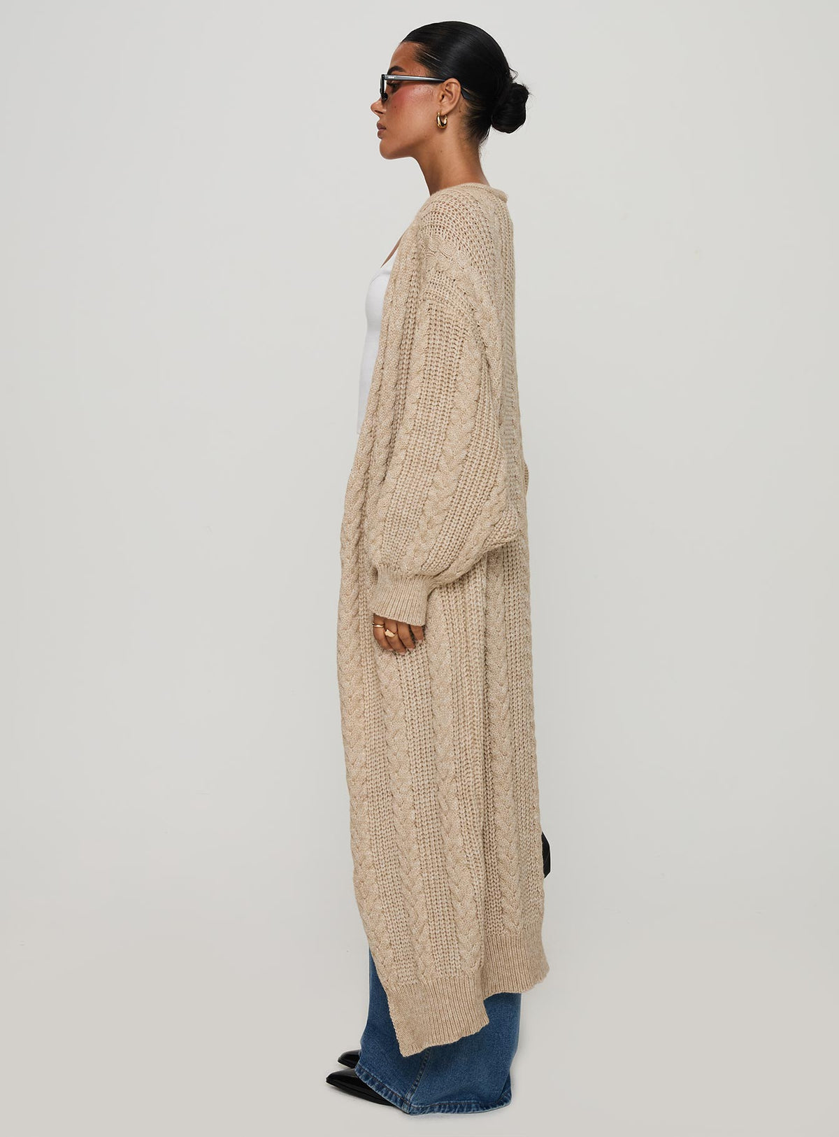 side view of model wearing Princess Polly Orkid Cable Knit Cardigan Beige Longline Jumpers Jumpers 