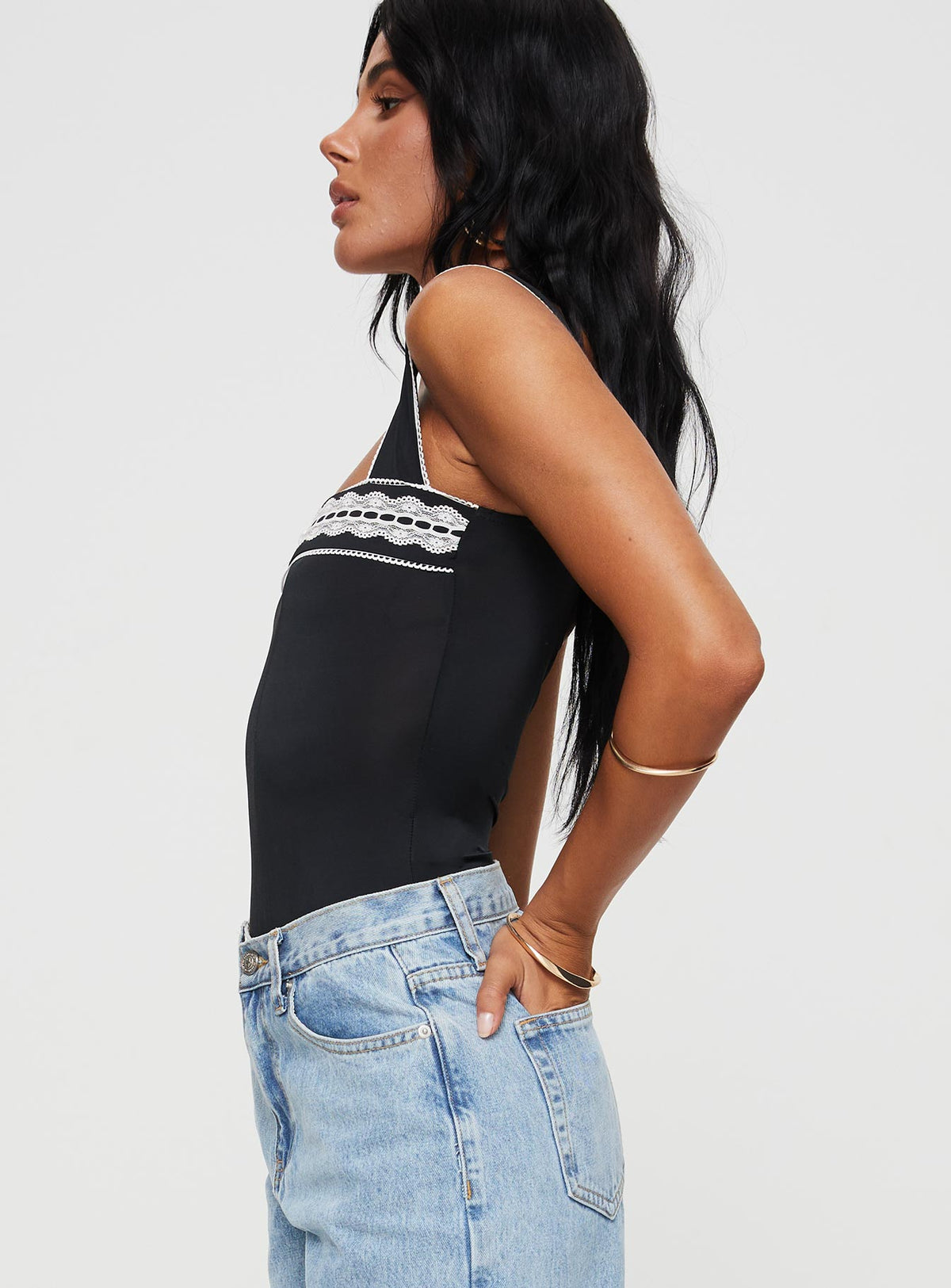 side view of model wearing Princess Polly Keating Bodysuit Black Sleeveless Bodysuit 