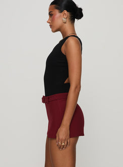 side view of model wearing Princess Polly Centre Stage Cut Out Bodysuit Black Sleeveless Bodysuit 