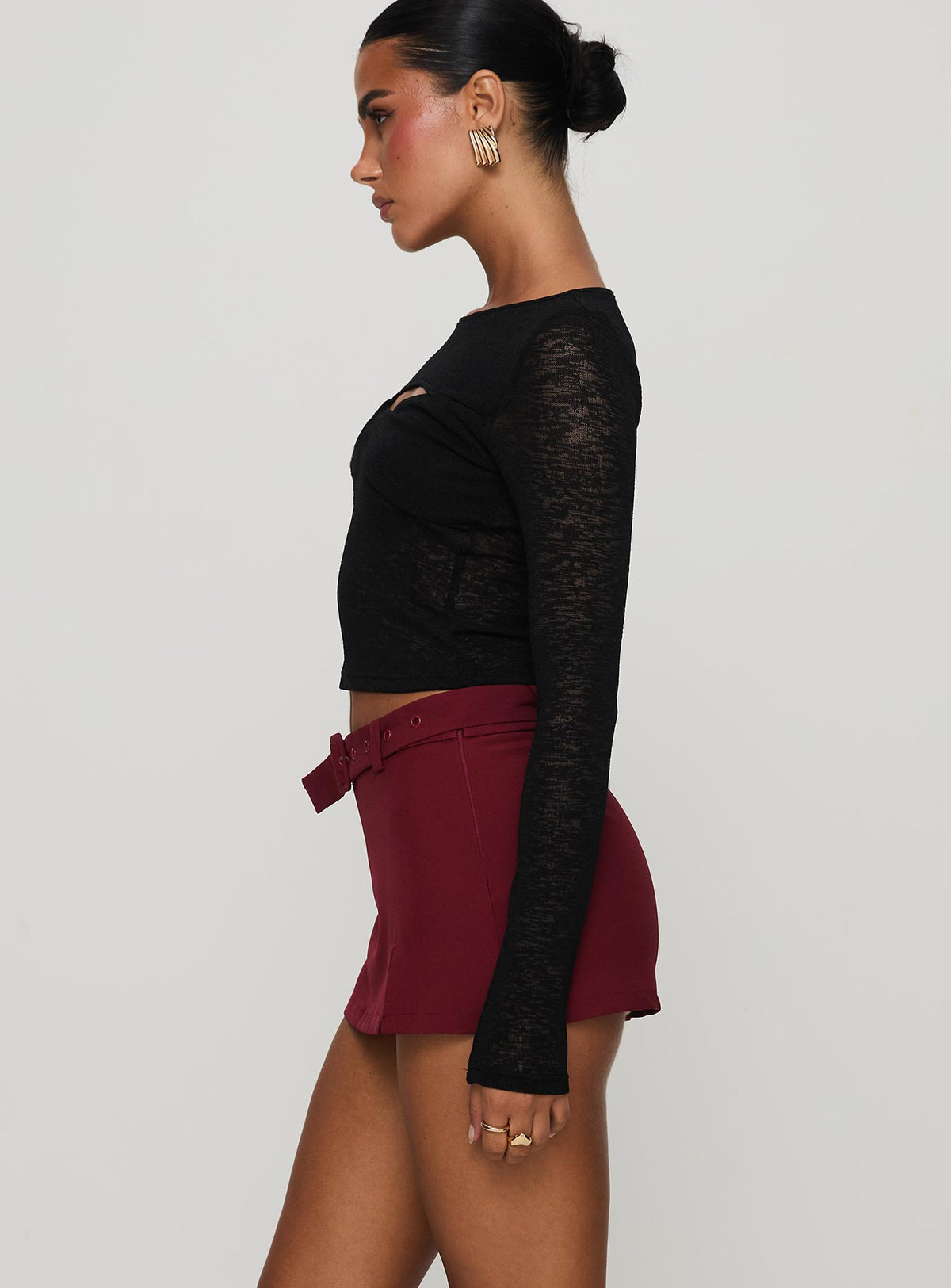 side view of model wearing Princess Polly Volley Mini Skort Cherry Red Tall High Waisted Shorts 