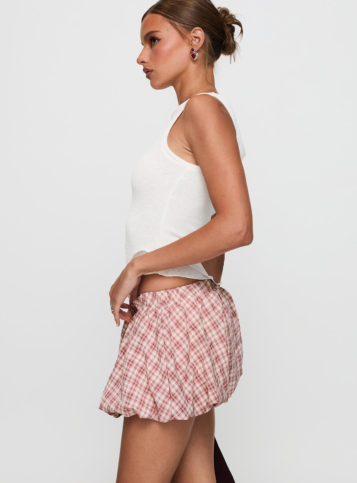 side view of model wearing Princess Polly Cydnee Bubble Hem Mini Skort Red Multi Low Rise Shorts 
