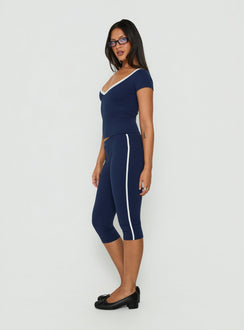 Showcasing the Rowanna Sporty Capri Pants Navy / Cream womens-regular-pants in high-rise side view of model wearing Princess Polly
