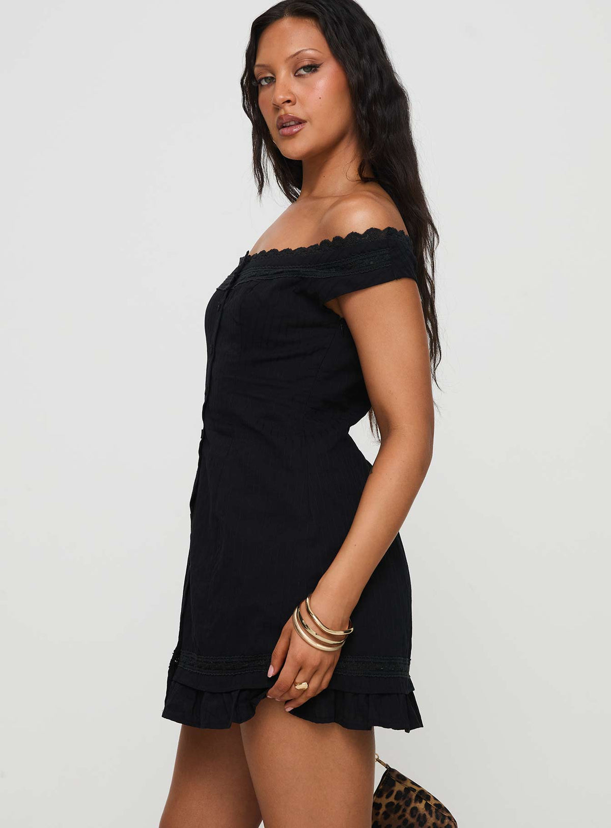 side view of model wearing Princess Polly Mirrorball Off The Shoulder Mini Dress Black Straight Neck 