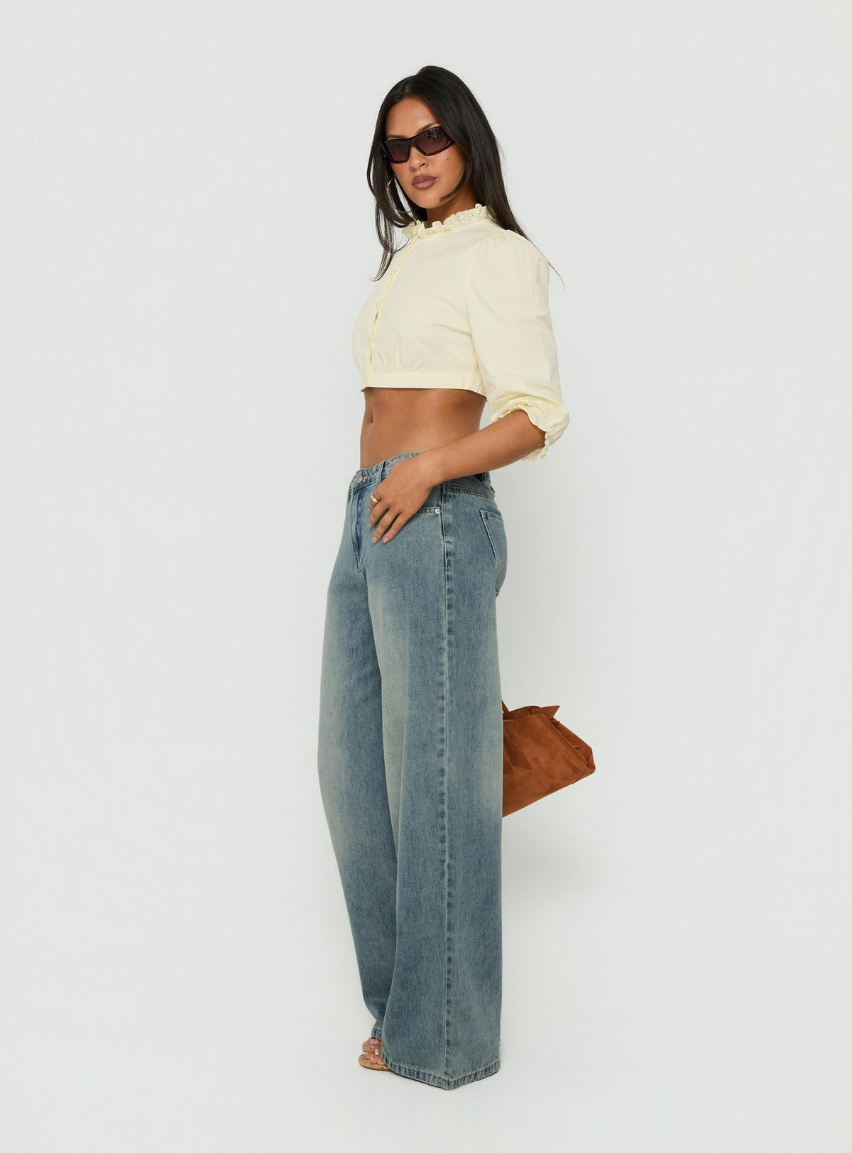 Showcasing the Karlos Low Rise Cinched Baggy Jeans Vintage Mid Blue Wash in womens-jeans with abstract print side view of model wearing Princess Polly