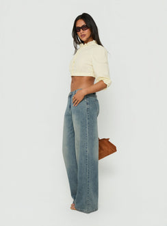 Showcasing the Karlos Low Rise Cinched Baggy Jeans Vintage Mid Blue Wash in womens-jeans with abstract print side view of model wearing Princess Polly