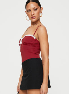 side view of model wearing Princess Polly Damsel Bodysuit Burgundy Sleeveless Bodysuit 