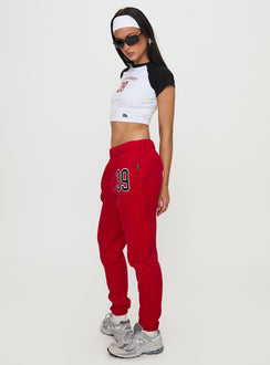 side view of model wearing Princess Polly BU Sweatpants Red High Rise Pants Pants 