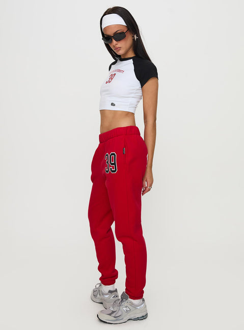 side view of model wearing Princess Polly BU Sweatpants Red High Rise Pants Pants 