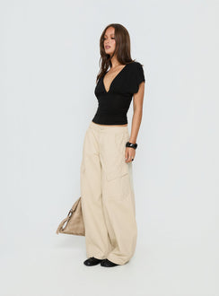 side view of model wearing Princess Polly Selective Memory Low Rise Wide Leg Cargo Pants Cream Low Rise Pants Pants 