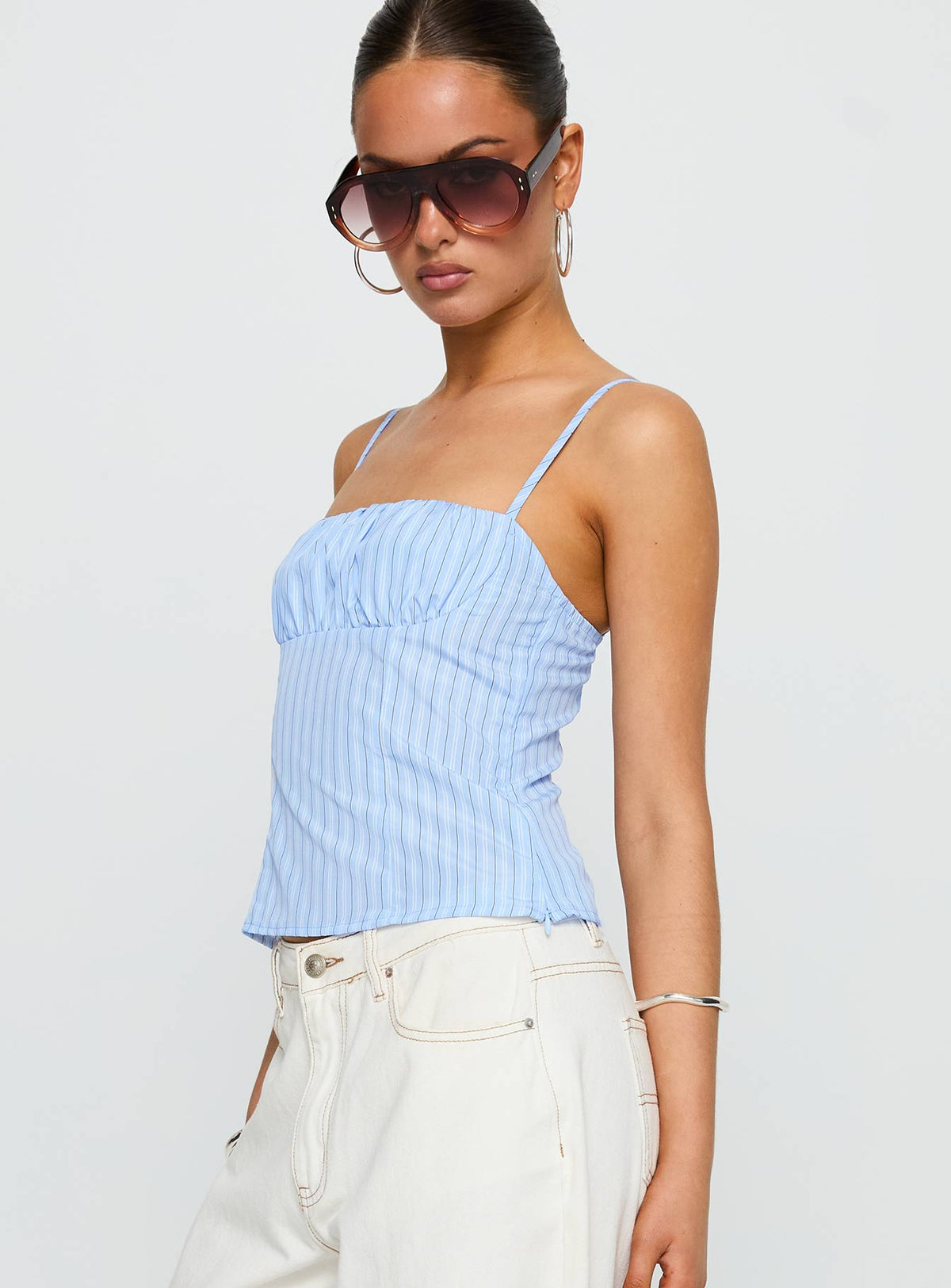 side view of model wearing Princess Polly Isolabella Top Blue Stripe Sleeveless Square Neck 