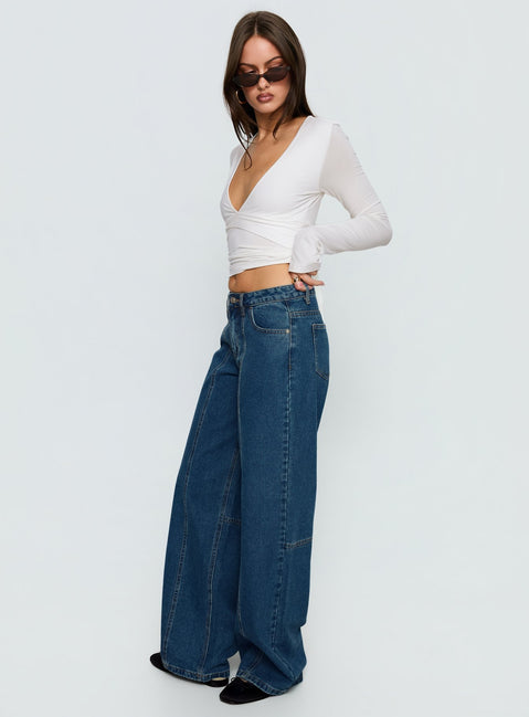 side view of model wearing Princess Polly Lando Low Rise Straight Leg Jeans Mid Blue Wash Mid Rise Jeans Jeans 