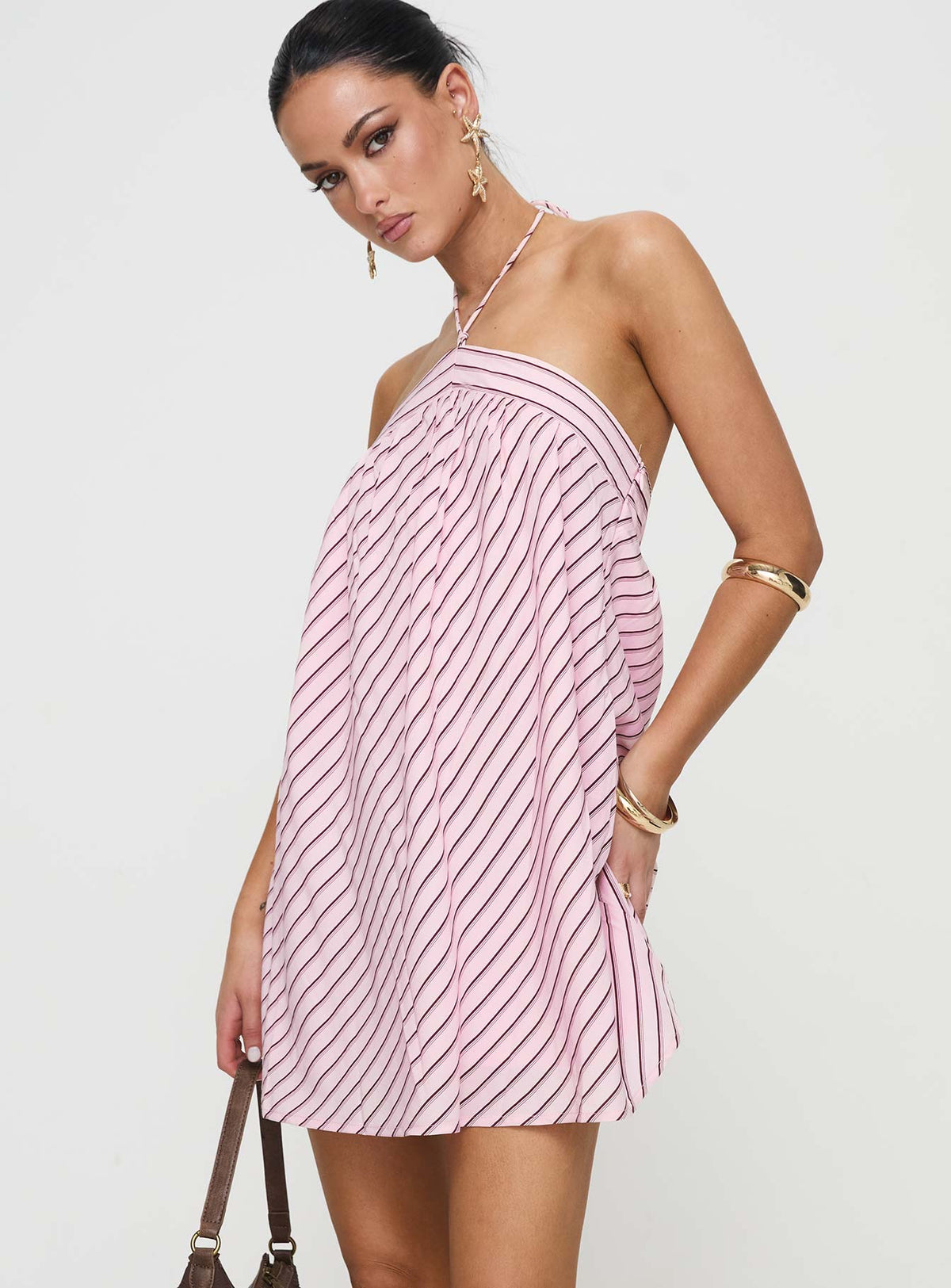 side view of model wearing Princess Polly Moonlit Mini Dress Pink Stripe Petite Asymmetric Neckline 