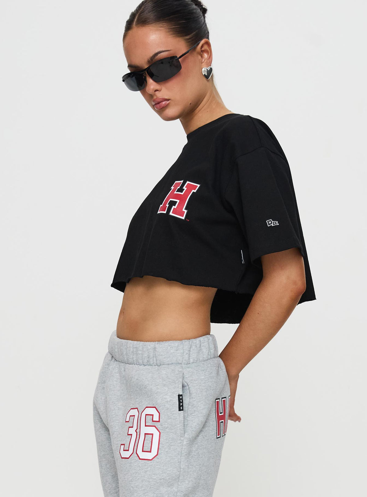 side view of model wearing Princess Polly Harvard Graphic Track Top Black Short Sleeves Crew Neck 