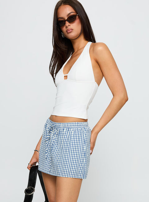 side view of model wearing Princess Polly My Way Skort Blue Gingham Low Rise Shorts 