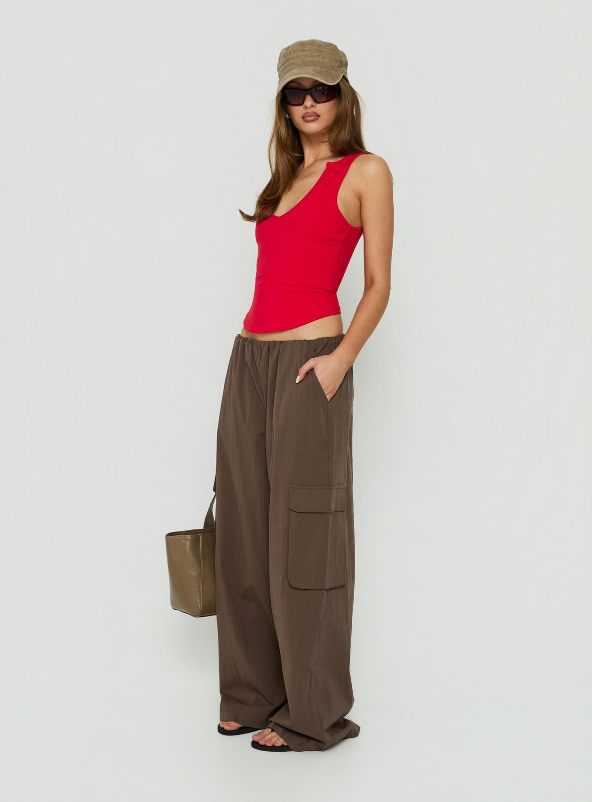 Crafted from the Lunea Concealed Waistband Cargo Pants Brown Petite in womens-regular-pants with mid-rise side view of model wearing Princess Polly