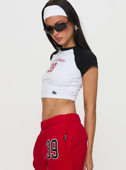 side view of model wearing Princess Polly Boston Homerun Graphic Top White / Black Short Sleeves Crew Neck 
