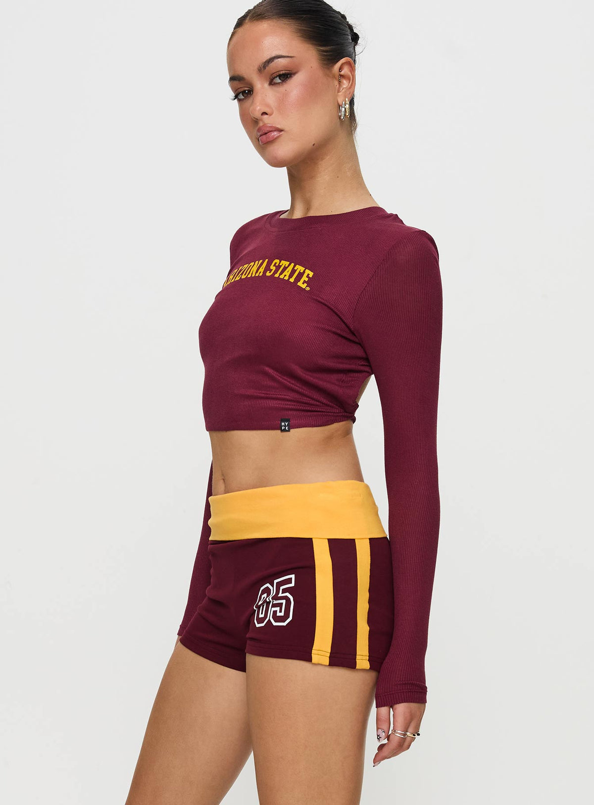 side view of model wearing Princess Polly ASU Foldover Shorts Maroon Low Rise Shorts 