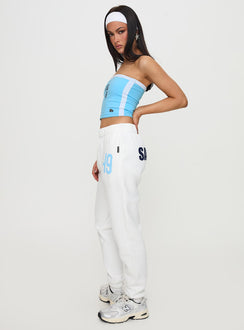 Featuring the USD Sweatpants White in womens-regular-pants with mid-rise waist, side view of model wearing Princess Polly