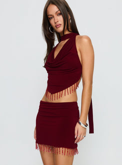  side view of model wearing Princess Polly Ginah Bead Tassel Mini Skirt Red Mini Skirts Skirts 