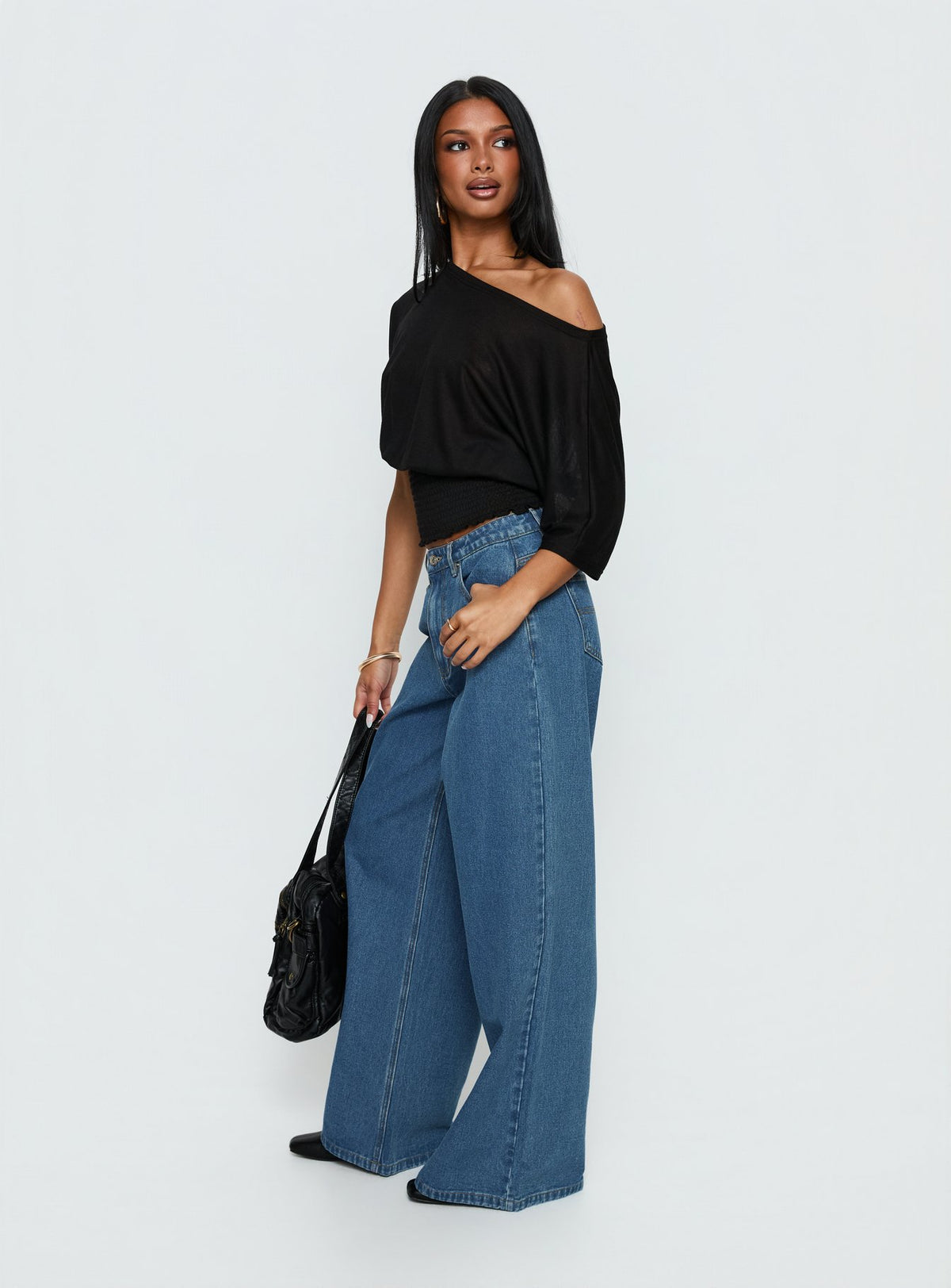 back view of model wearing Princess Polly Naylor Mid Rise Wide Leg Jeans Mid Blue Wash Mid Rise Jeans Jeans 