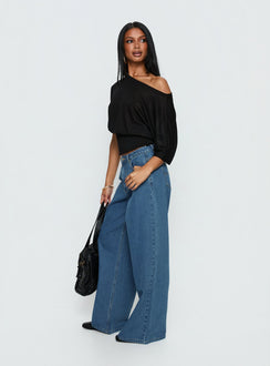 back view of model wearing Princess Polly Naylor Mid Rise Wide Leg Jeans Mid Blue Wash Mid Rise Jeans Jeans 