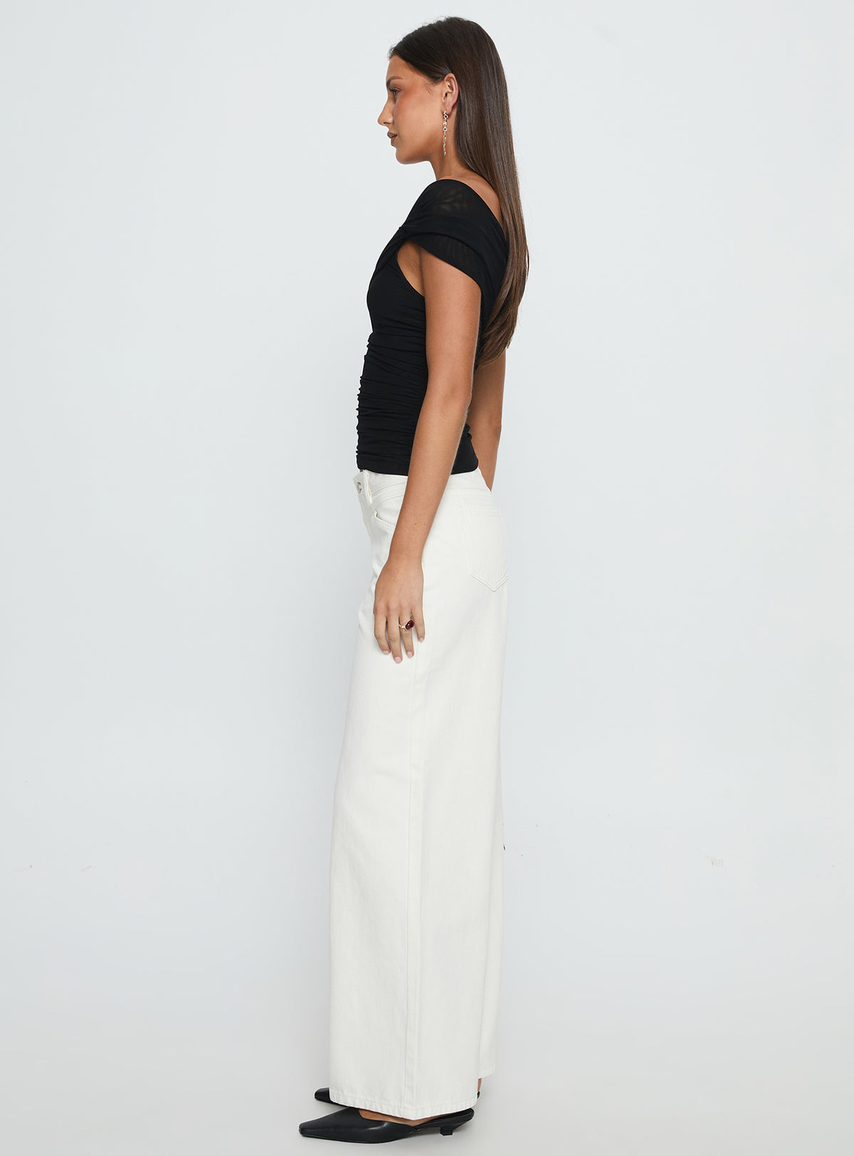 side view of model wearing Princess Polly Catiana Low Rise Wide Leg Jeans White Low Rise Jeans Jeans 